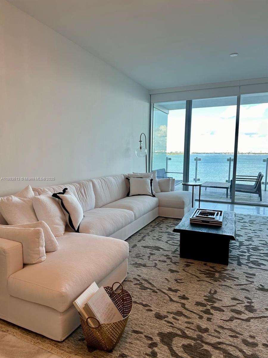 700 Northeast 26th Terrace, Unit 803 Miami, FL 33137 - Photo 4 of 13 a living room with furniture and a floor to ceiling window