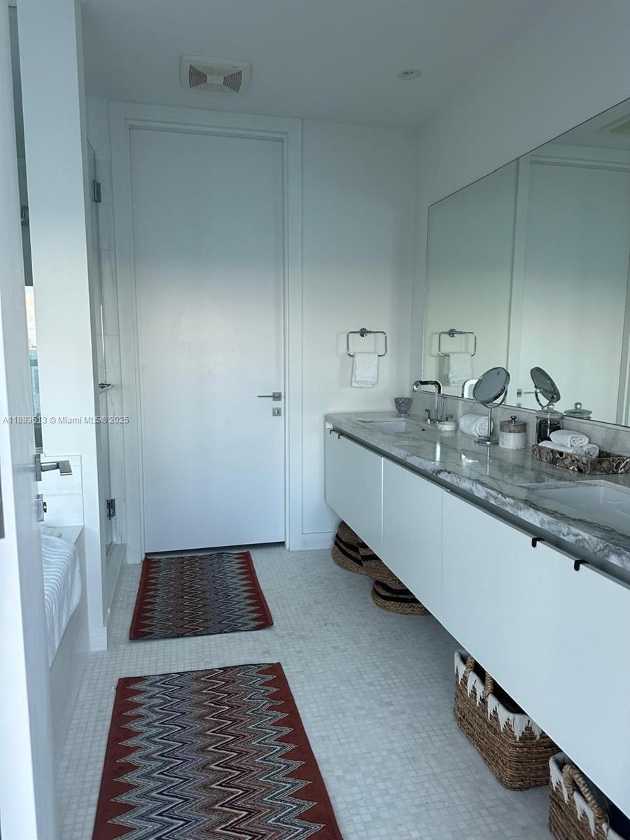 700 Northeast 26th Terrace, Unit 803 Miami, FL 33137 - Photo 8 of 13 a bathroom with a sink and a mirror