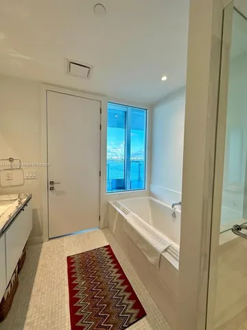 a bathroom with a bathtub and a shower