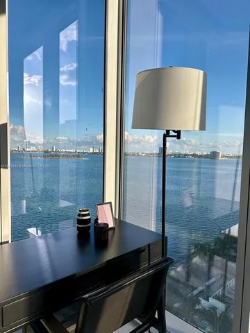 a view of a bathroom with a sink and a mirror