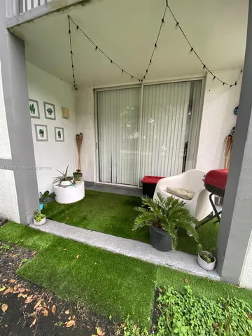 a front view of a house with a yard and sitting area
