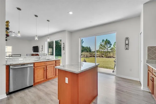 a kitchen with granite countertop kitchen island and stainless steel appliances