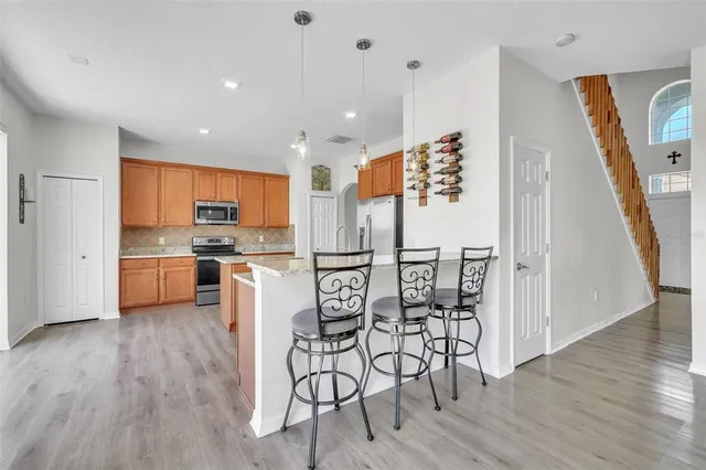 a view of kitchen with cabinets and wooden floor