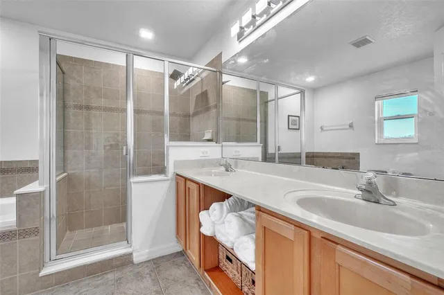 a bathroom with a sink double vanity and shower