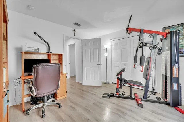 a view of a workspace with furniture and gym equipment