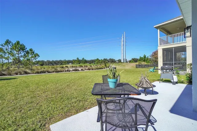 a view of a lake with table and chairs
