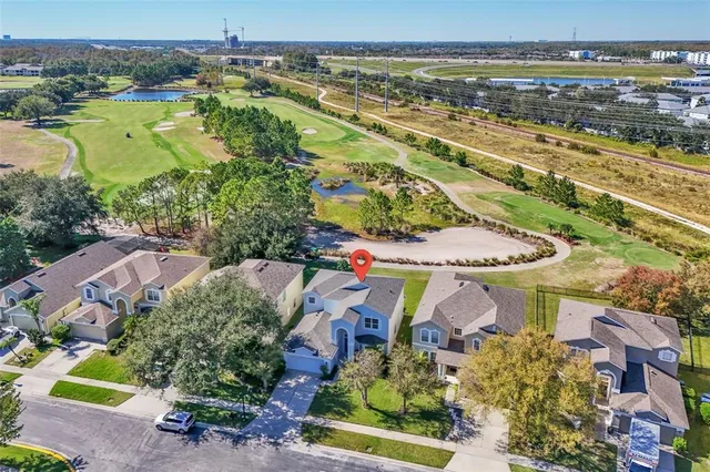 an aerial view of residential houses with outdoor space and swimming pool