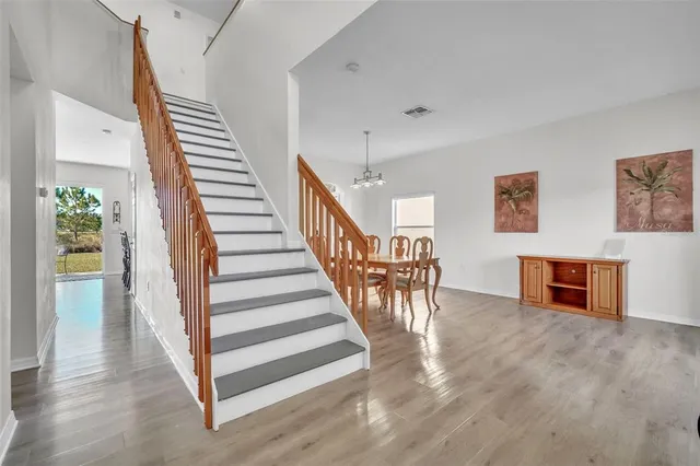 a view of entryway and hall with wooden floor