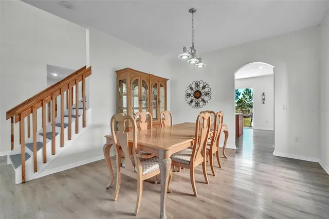 a view of a dining room with furniture wooden floor and chandelier