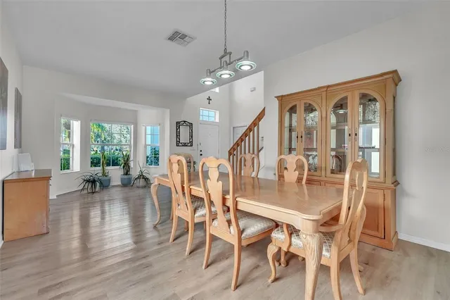 a view of a dining room with furniture window and wooden floor