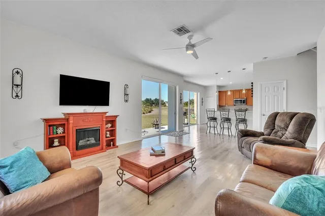 a living room with fireplace furniture and a flat screen tv