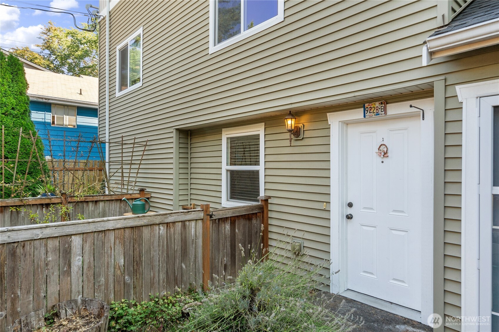 a view of a house with a small yard and wooden fence