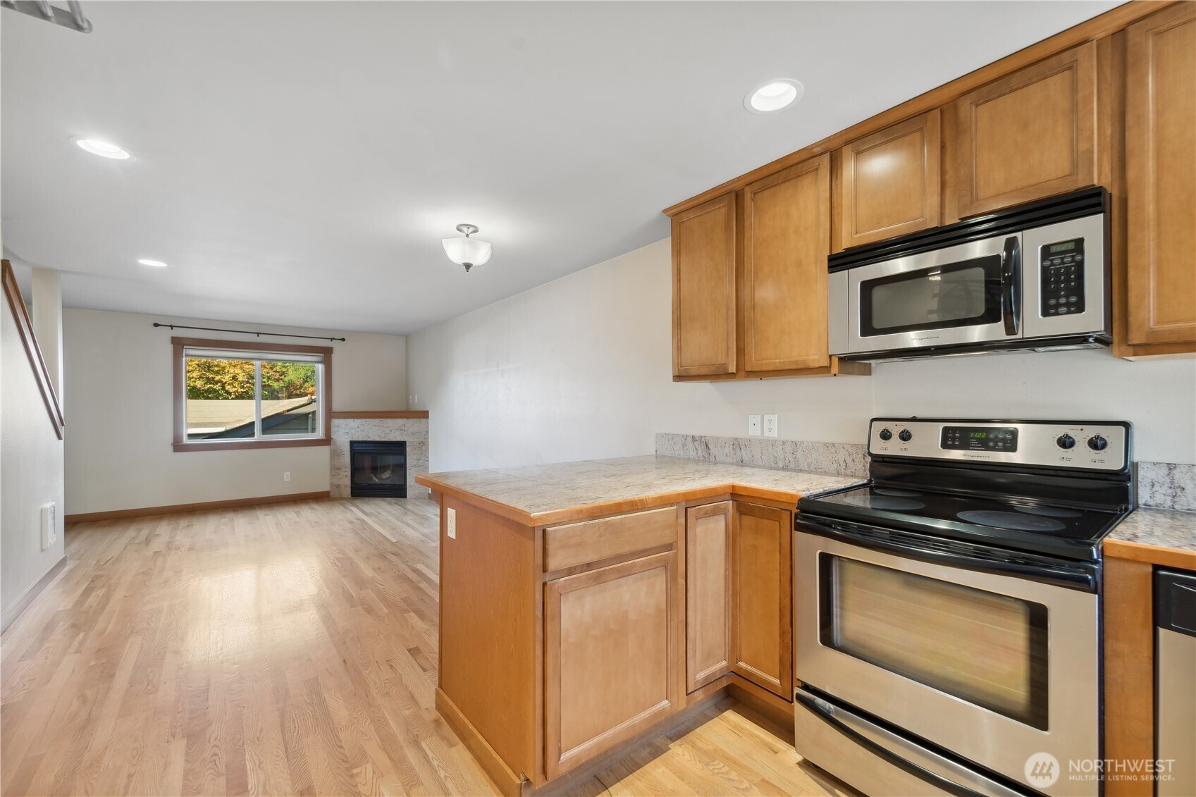 9228 15th Avenue Southwest, Unit B Seattle, WA 98106 - Photo 4 of 16 a kitchen with stainless steel appliances a stove microwave and sink