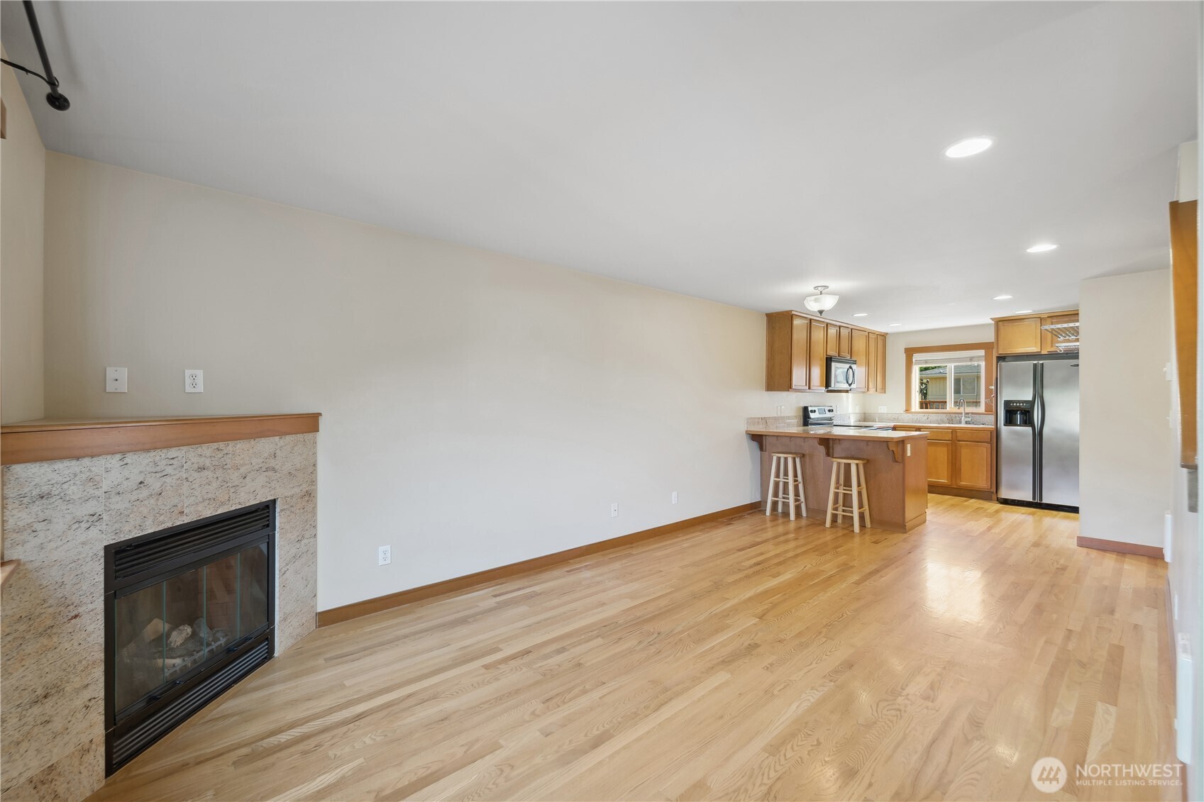 9228 15th Avenue Southwest, Unit B Seattle, WA 98106 - Photo 8 of 16 a living room with furniture and a fireplace