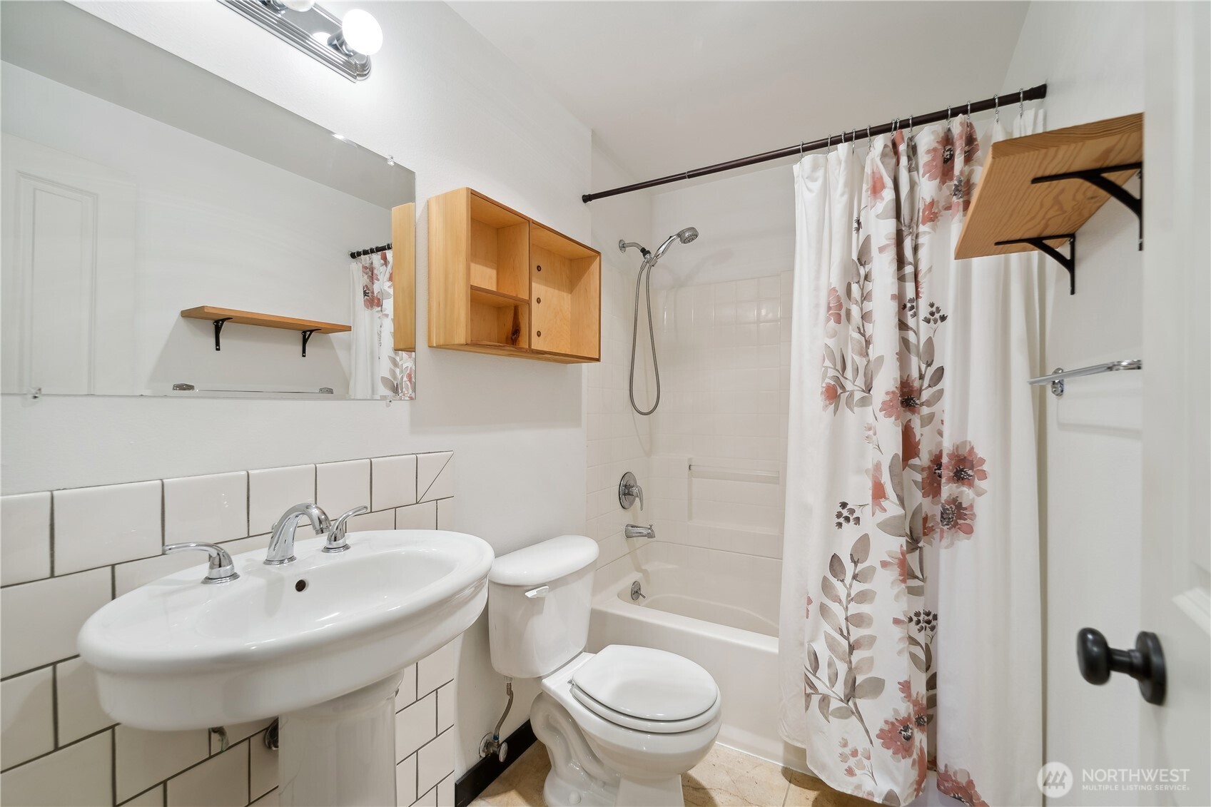 9228 15th Avenue Southwest, Unit B Seattle, WA 98106 - Photo 9 of 16 a white toilet sitting next to a bathroom sink
