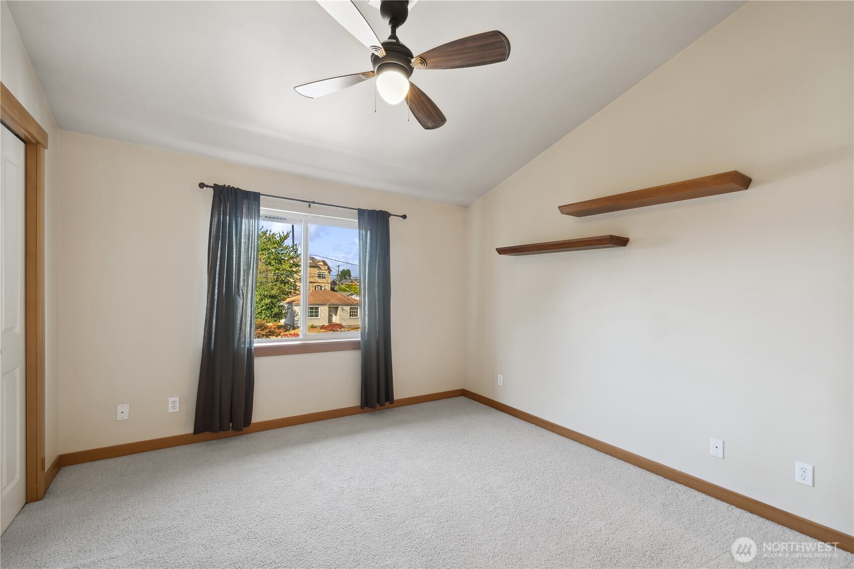 9228 15th Avenue Southwest, Unit B Seattle, WA 98106 - Photo 10 of 16 an empty room with windows and ceiling fan