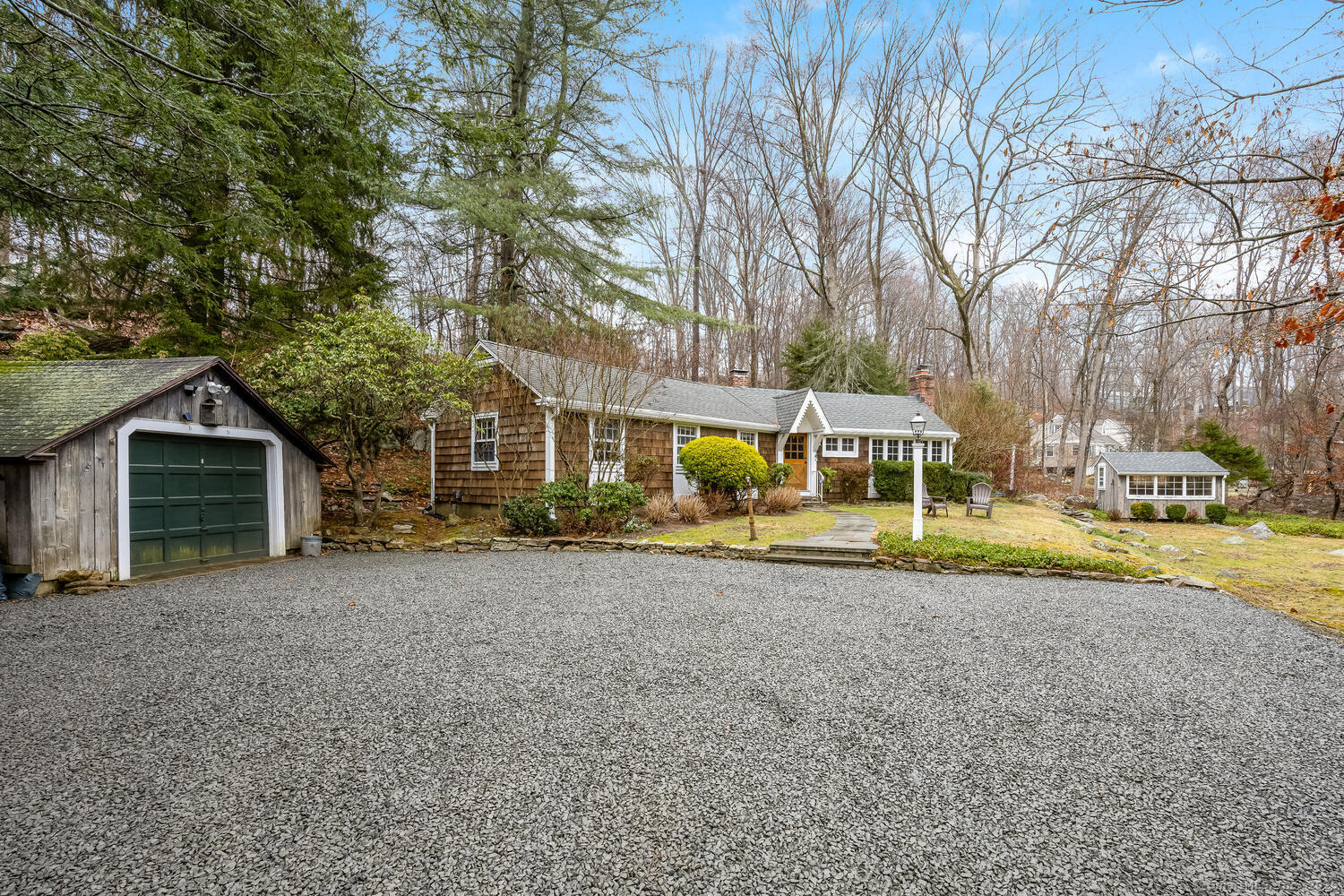 a view of a house with a yard and sitting area