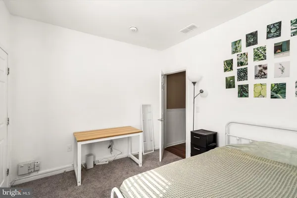 a bedroom with a bed and a chair