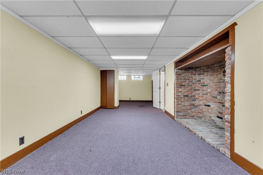3842 Wallingford Road South Euclid, OH 44121 - Photo 27 of 31 Basement with brick wall, a paneled ceiling, and carpet