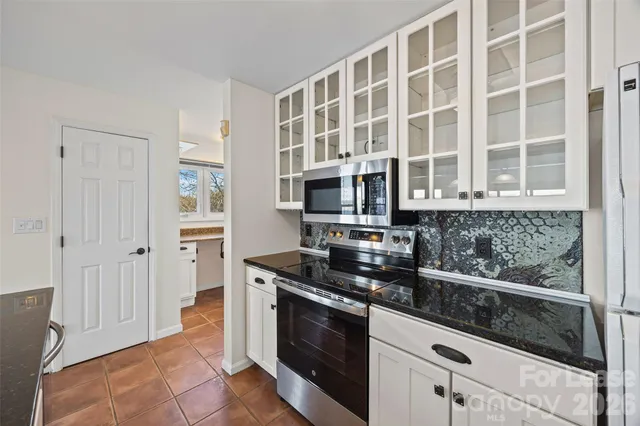 a kitchen with granite countertop a sink and a stove