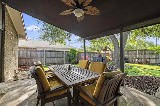 a view of a patio with a table chairs and a table