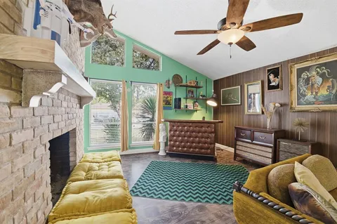 a living room with furniture a flat screen tv and a fireplace