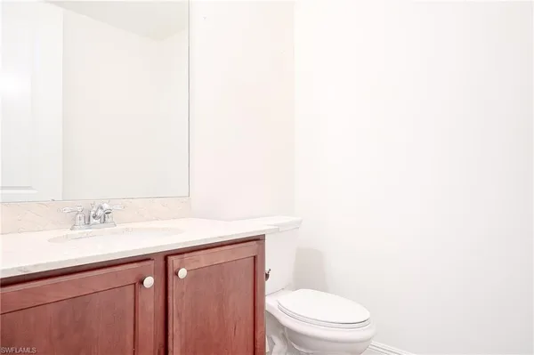 a bathroom with a sink a toilet and mirror