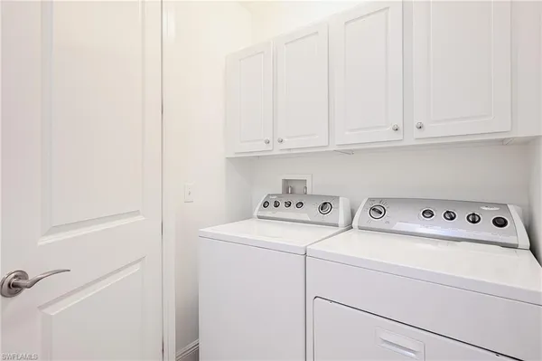 a view of storage and utility room with washer and dryer