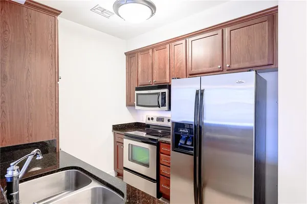 a kitchen with a refrigerator and a sink