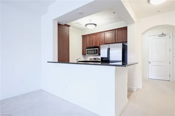 a kitchen with cabinets and stainless steel appliances