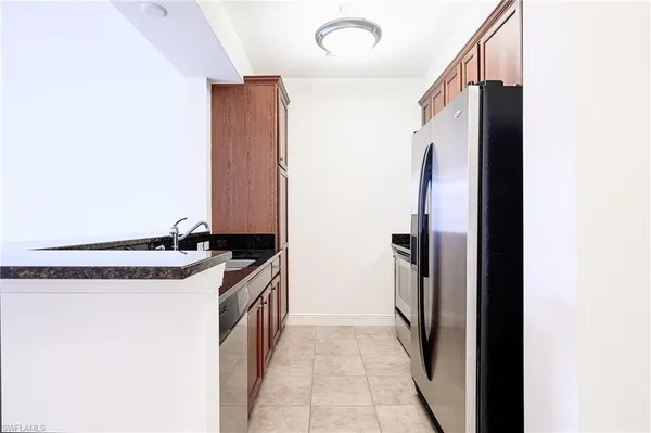 a kitchen with stainless steel appliances granite countertop a refrigerator and a sink