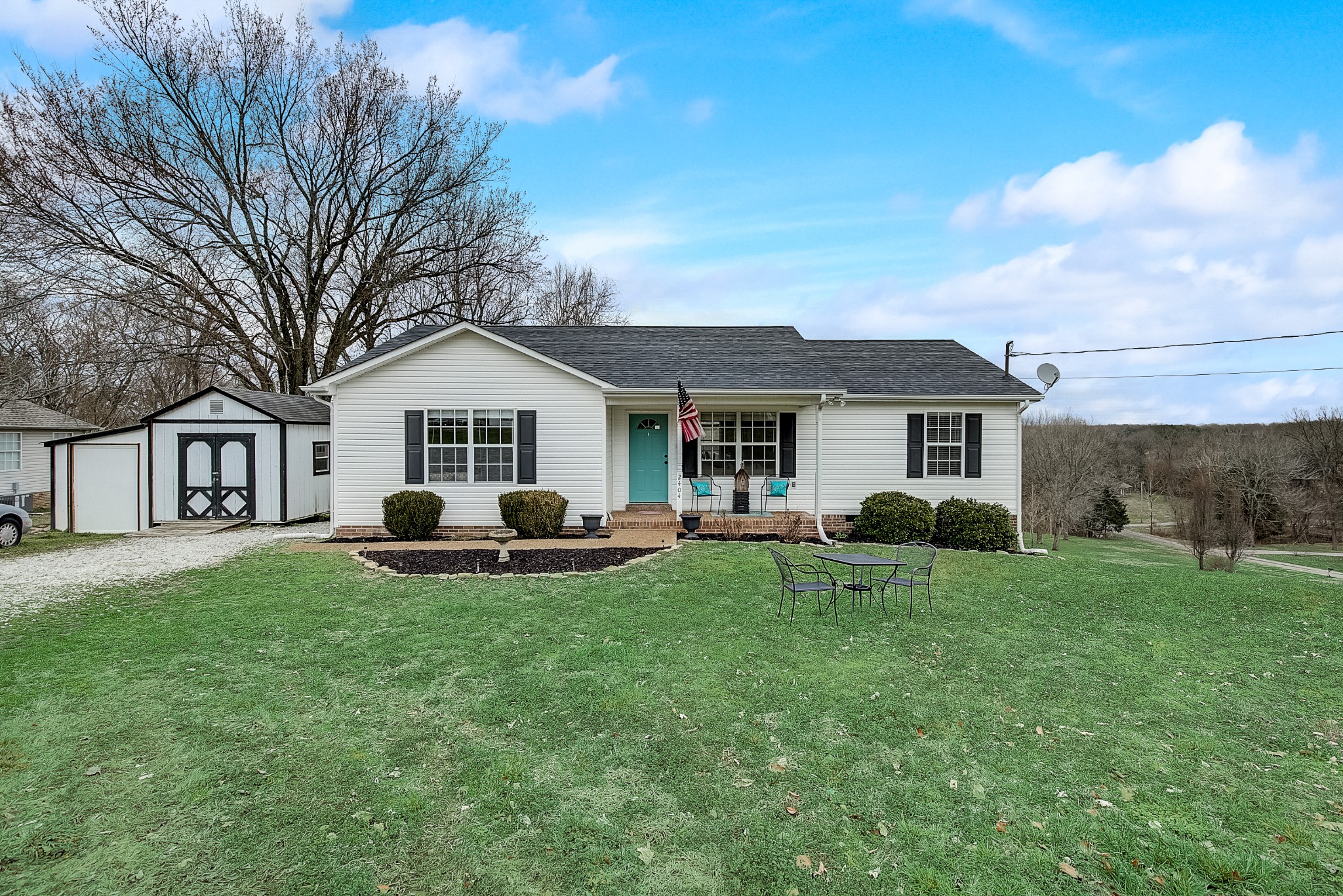 a view of a house with a yard and porch