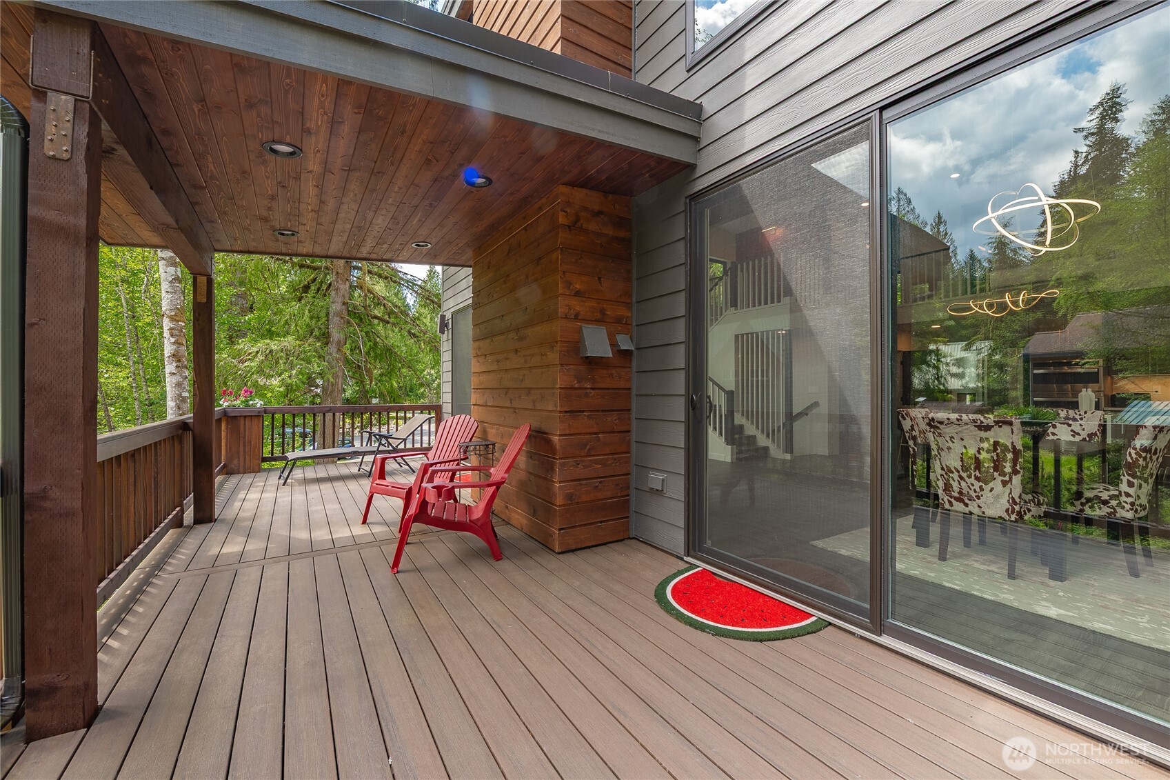 12031 Shuksan Rim Drive Deming, WA 98244 - Photo 16 of 39 a balcony with wooden floor table and chairs