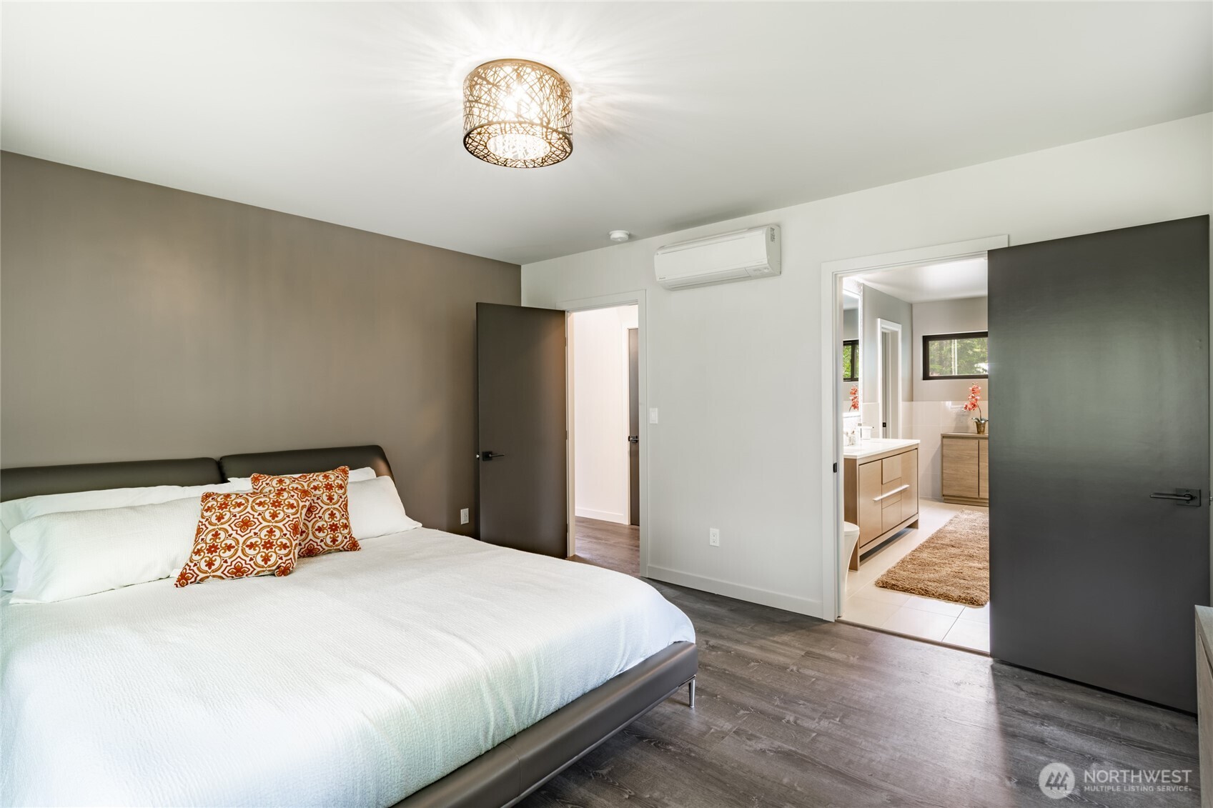 12031 Shuksan Rim Drive Deming, WA 98244 - Photo 19 of 39 a bedroom with a bed and a chandelier