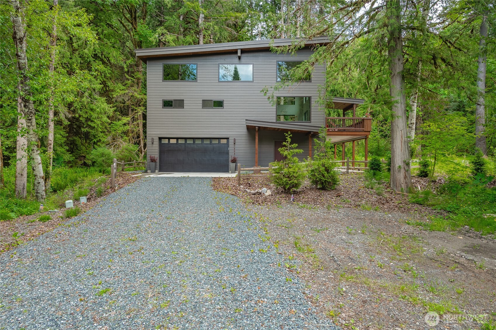 12031 Shuksan Rim Drive Deming, WA 98244 - Photo 37 of 39 a front view of a house with a yard and garage