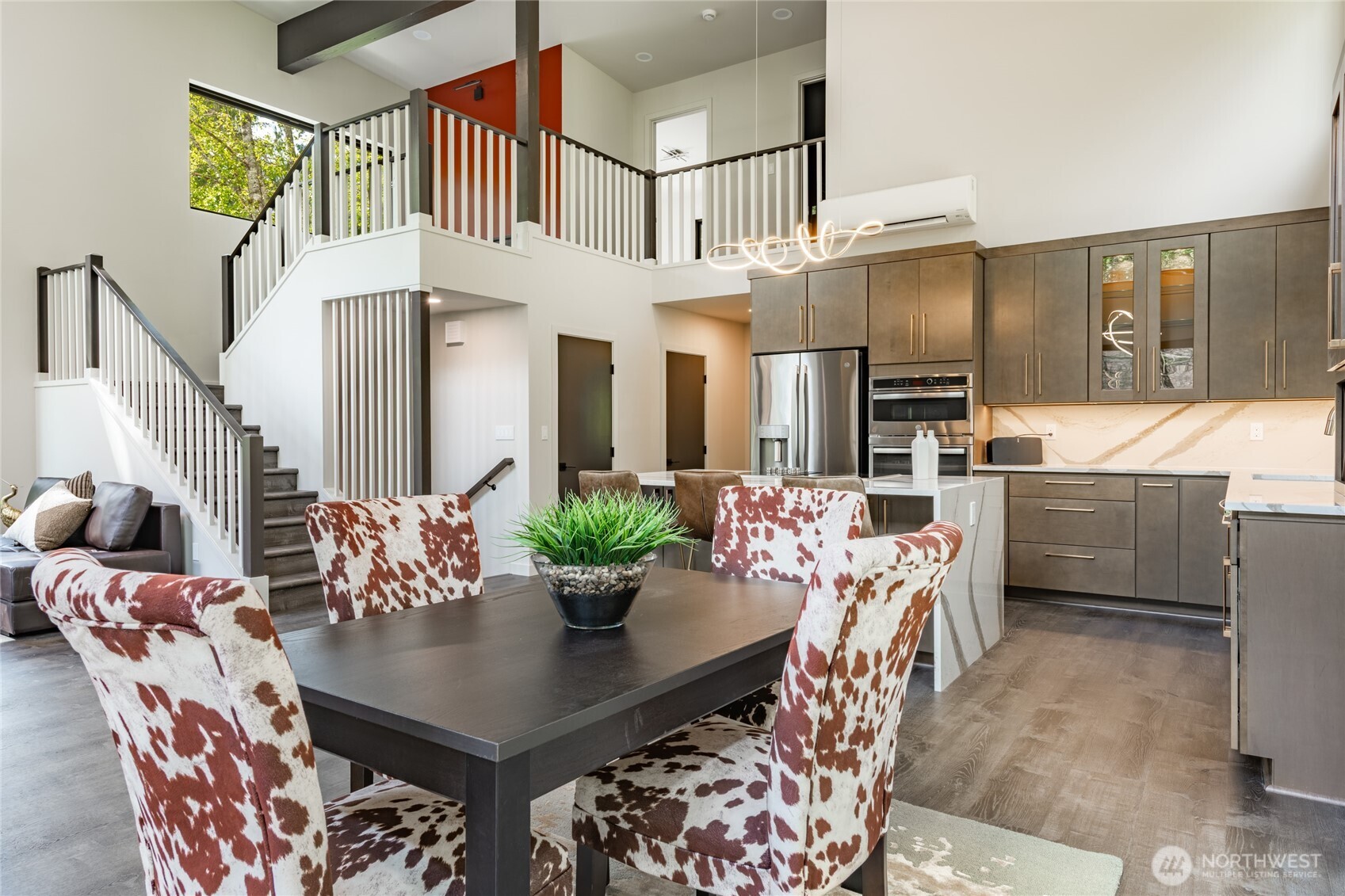 12031 Shuksan Rim Drive Deming, WA 98244 - Photo 5 of 39 a view of a dining room and livingroom with furniture a rug a potted plant and a chandelier