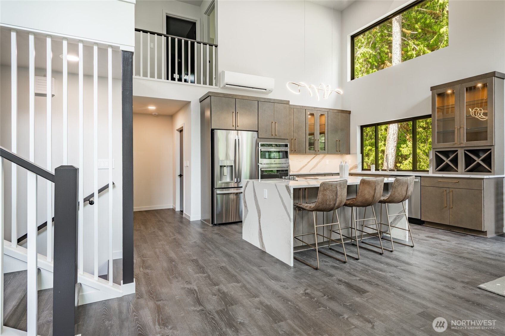 12031 Shuksan Rim Drive Deming, WA 98244 - Photo 6 of 39 a kitchen with stainless steel appliances a dining table chairs refrigerator and sink