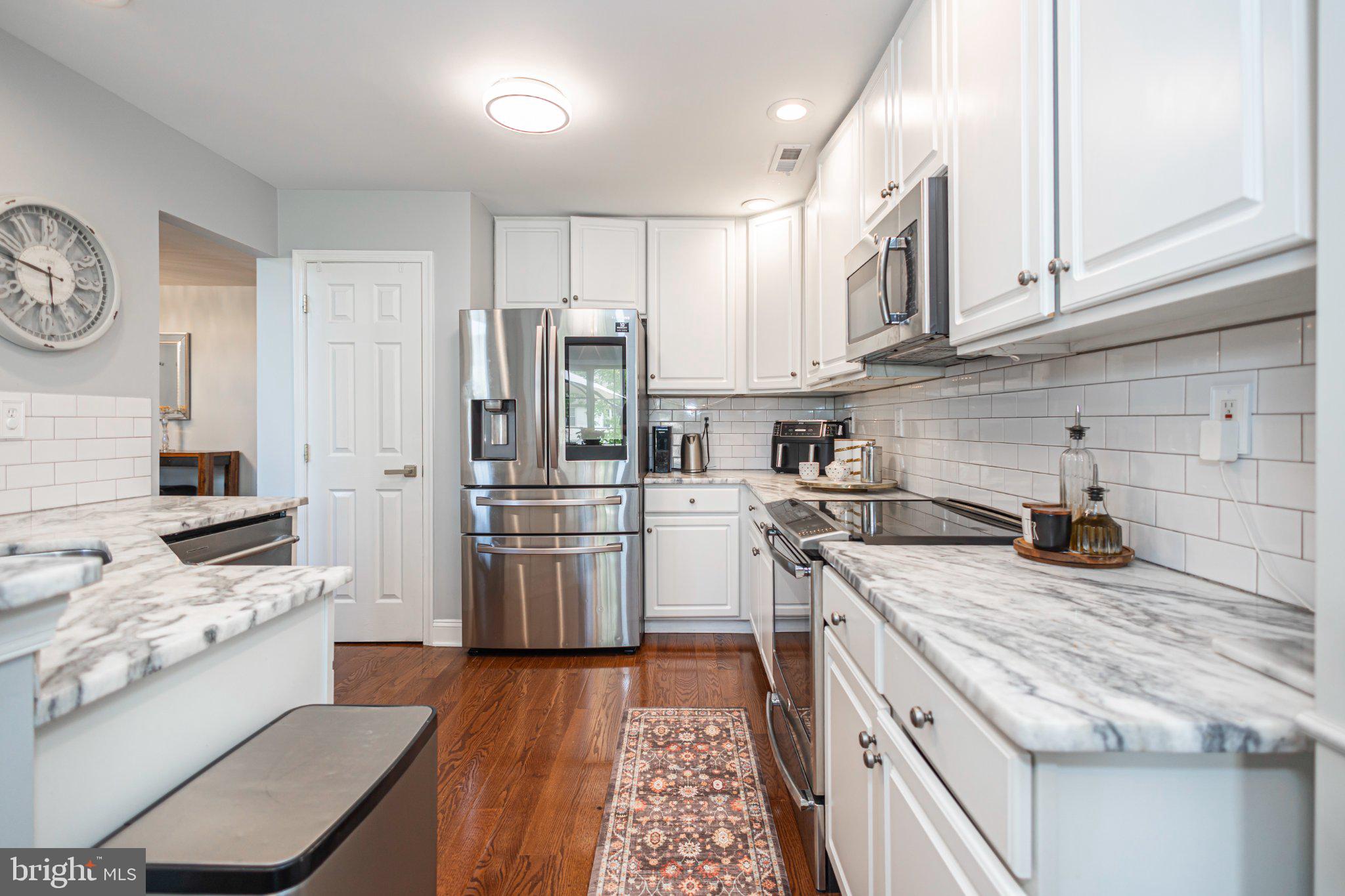 5086 Raintree Court Doylestown, PA 18902 - Photo 11 of 42 White cabinets & quartz counters