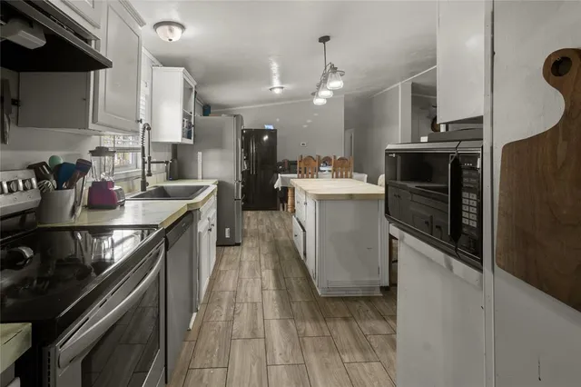 a kitchen with refrigerator and stove