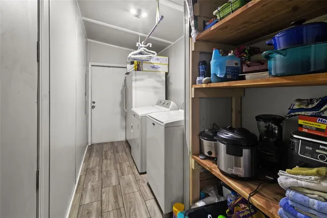 a kitchen with a refrigerator and a stove top oven