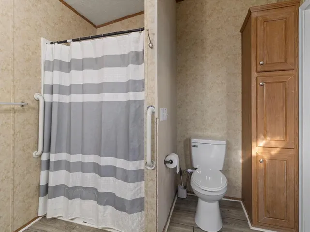 a bathroom with a toilet and shower