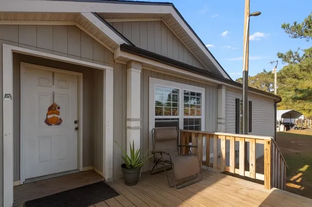 a view of a house with a door and wooden floor