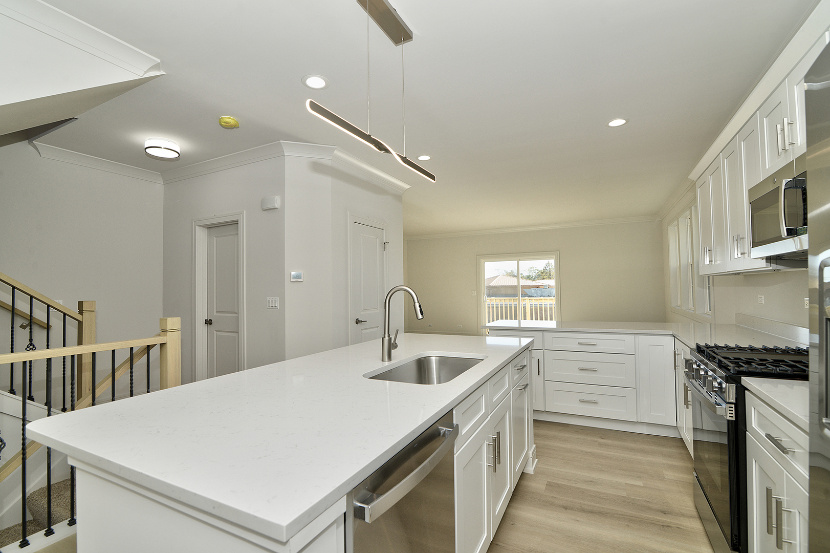 214 North Walnut Street Bensenville, IL 60106 - Photo 12 of 42 a kitchen with granite countertop a sink stainless steel appliances a counter space and cabinets
