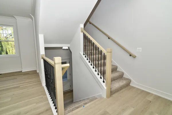 a view of a hallway with staircase and floors
