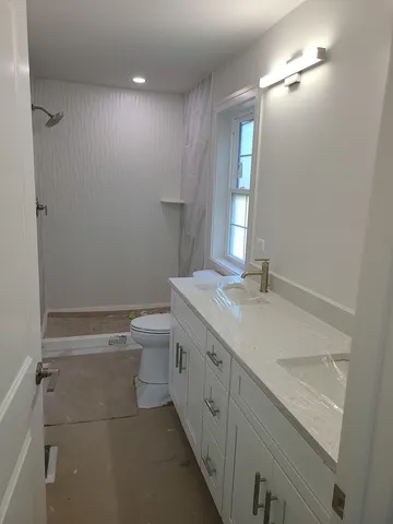 a room with linen closet and wooden floor