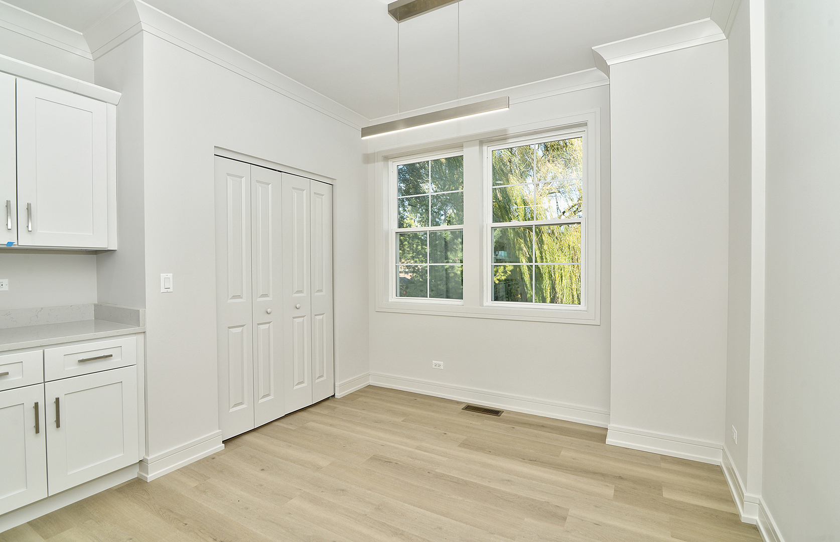214 North Walnut Street Bensenville, IL 60106 - Photo 21 of 42 a view of an empty room with a window and wooden floor