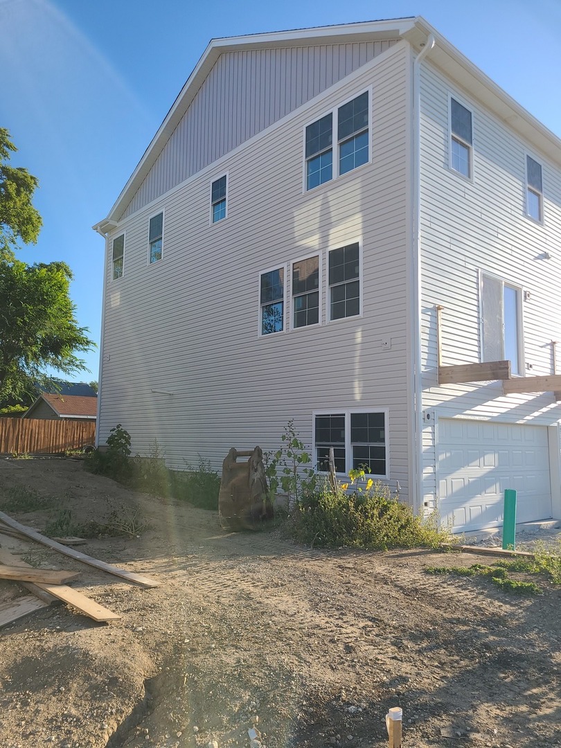 214 North Walnut Street Bensenville, IL 60106 - Photo 30 of 42 a front view of a house with garden