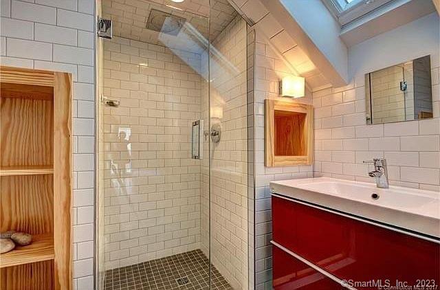 15 Merwin Avenue Milford, CT 06460 - Photo 18 of 23 a bathroom with a sink a shower and a mirror