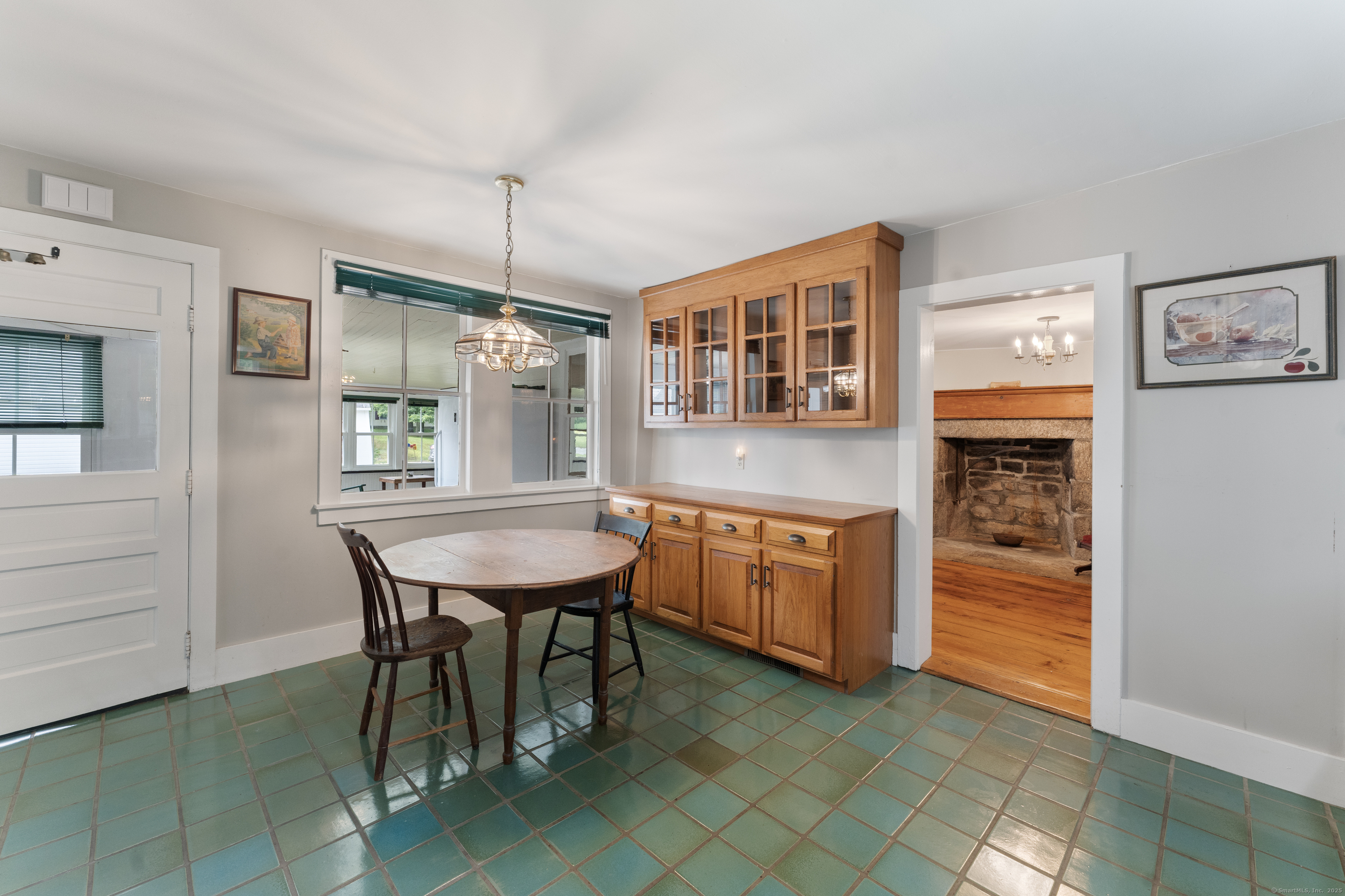 393 North Canterbury Road Canterbury, CT 06331 - Photo 12 of 40 a kitchen with a table chairs and refrigerator