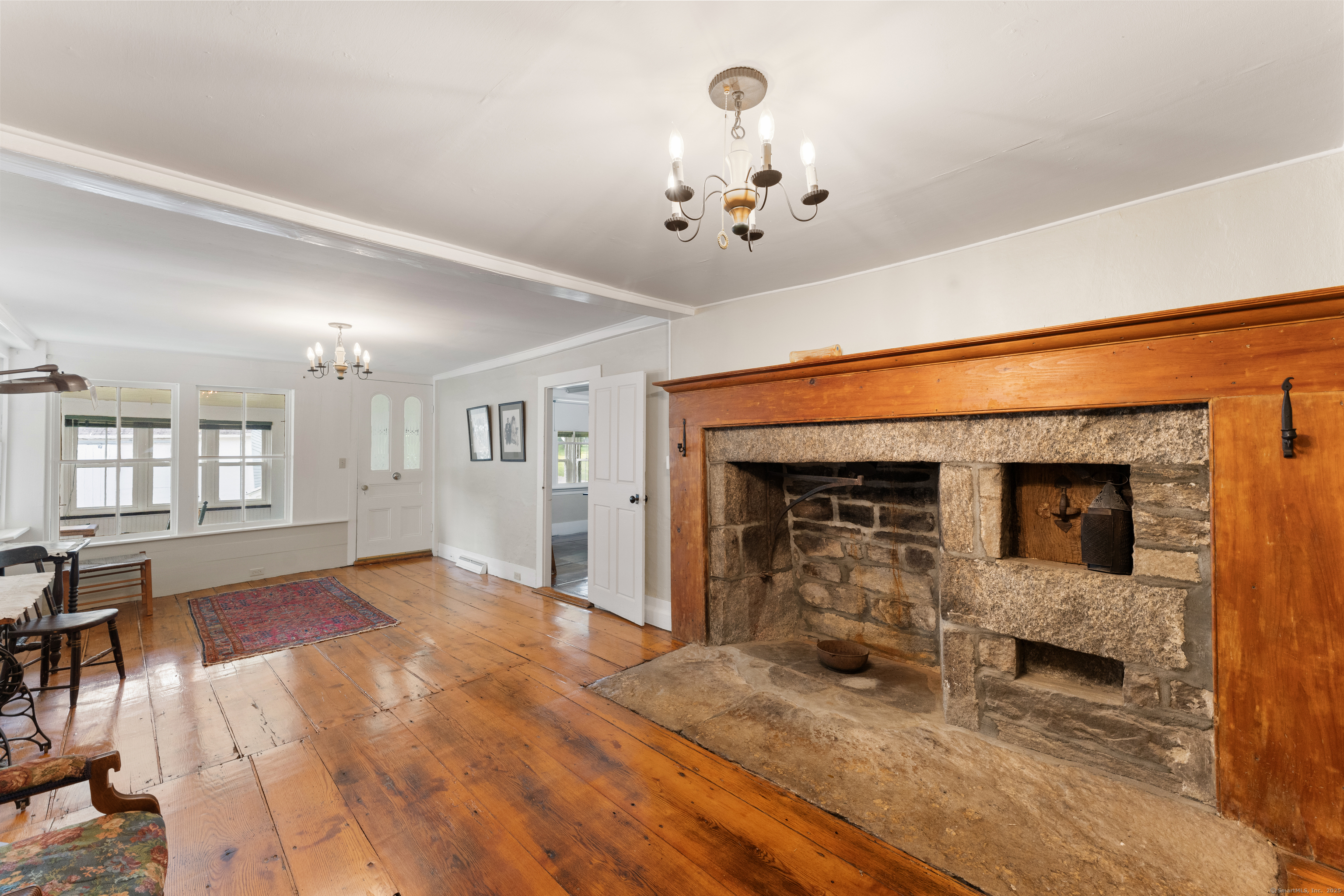 393 North Canterbury Road Canterbury, CT 06331 - Photo 13 of 40 a view of a livingroom with wooden floor and a fireplace